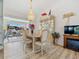 Elegant dining area with a chandelier, cabinet, and sliding glass doors that provide views of the screened-in lanai at 1346 Osprey Dr, Punta Gorda, FL 33950