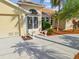 Welcoming front entrance features a decorative door, well-maintained landscaping, and a paved driveway at 1346 Osprey Dr, Punta Gorda, FL 33950