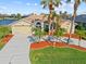 Charming single-story home boasts a lush landscaped front yard and a spacious two-car garage at 1346 Osprey Dr, Punta Gorda, FL 33950