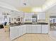 Open kitchen featuring white cabinets, granite countertops, and tile flooring at 1346 Osprey Dr, Punta Gorda, FL 33950