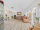 Bright and airy living room with vaulted ceilings, a large sectional sofa, and lots of natural light at 1346 Osprey Dr, Punta Gorda, FL 33950