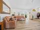 Spacious living room featuring a sectional sofa, stylish decor, and an abundance of natural light from large windows at 1346 Osprey Dr, Punta Gorda, FL 33950