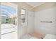Bathroom with shower, access to patio, and updated fixtures at 1426 Natrona Dr, North Port, FL 34286