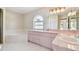 Bathroom features pink vanity and a corner bathtub at 1426 Natrona Dr, North Port, FL 34286