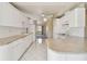 Kitchen with white cabinets and a large island at 1426 Natrona Dr, North Port, FL 34286