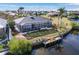 Aerial view of house and backyard, featuring a screened porch and private dock at 1454 Kiwi Ct, Punta Gorda, FL 33950