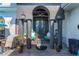 Covered back porch with comfortable seating and decorative planters at 1454 Kiwi Ct, Punta Gorda, FL 33950