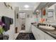 Elegant bathroom with double sinks, a large mirror, and a walk-in shower at 1454 Kiwi Ct, Punta Gorda, FL 33950