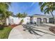 Front view of a two-story house with palm trees and a two-car garage at 1454 Kiwi Ct, Punta Gorda, FL 33950