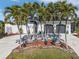 White house with palm trees, circular driveway, and two-car garage at 1454 Kiwi Ct, Punta Gorda, FL 33950