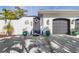 Front entrance with decorative door and two large planters at 1454 Kiwi Ct, Punta Gorda, FL 33950