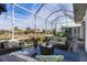 Spacious screened-in patio with comfortable seating and water views at 1454 Kiwi Ct, Punta Gorda, FL 33950