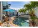 Stunning pool and patio area with lush landscaping and a waterfall feature at 1454 Kiwi Ct, Punta Gorda, FL 33950