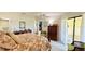 King-size bed, wooden furniture, and sliding door access to outside at 1640 Atares Dr # 31, Punta Gorda, FL 33950