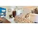 Comfortable bedroom with a king bed, sitting area, and view into living room at 1640 Atares Dr # 31, Punta Gorda, FL 33950