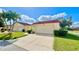 Front view of charming condo with attached garage and well-manicured lawn at 1640 Atares Dr # 31, Punta Gorda, FL 33950
