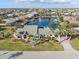 Aerial view of a waterfront home with a paved driveway and gorgeous landscaping in a quiet residential area at 1701 Casey Key Dr, Punta Gorda, FL 33950