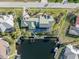 A bird's-eye view of a home featuring a private dock, pool, and lush landscaping in a waterfront community at 1701 Casey Key Dr, Punta Gorda, FL 33950