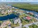 Wide aerial view of a waterfront community with many homes, canals and a view of the distant greenery at 1701 Casey Key Dr, Punta Gorda, FL 33950
