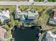 Aerial view of a beautiful home with a green roof, lush landscaping, and a private dock on the water at 1701 Casey Key Dr, Punta Gorda, FL 33950