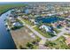 Wide aerial view of a community with canals and waterfront properties on a sunny day at 1701 Casey Key Dr, Punta Gorda, FL 33950