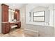 Bathroom featuring a tub, marble finishes and vanity with knee space at 1701 Casey Key Dr, Punta Gorda, FL 33950