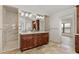 Bathroom featuring a double vanity with marble countertop and tile floor at 1701 Casey Key Dr, Punta Gorda, FL 33950