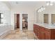 Open bathroom floorplan featuring marble tub, vanity and doorway to bedroom at 1701 Casey Key Dr, Punta Gorda, FL 33950