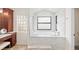 Modern bathroom with a soaking tub, natural light, and stylish finishes creating a tranquil oasis at 1701 Casey Key Dr, Punta Gorda, FL 33950