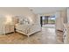 Bright bedroom featuring a large window with scenic views, offering a serene and airy atmosphere at 1701 Casey Key Dr, Punta Gorda, FL 33950