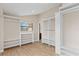 Spacious walk-in closet featuring built-in shelving and wood-look floors at 1701 Casey Key Dr, Punta Gorda, FL 33950