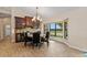 Elegant dining area features a stone table, stylish chandelier, and a beautiful bay window at 1701 Casey Key Dr, Punta Gorda, FL 33950