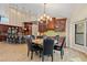 Modern dining area next to kitchen, featuring a round table, black chairs, and custom cabinets at 1701 Casey Key Dr, Punta Gorda, FL 33950