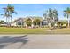 Beautiful single-Gathering home featuring lush tropical landscaping, a meticulously maintained lawn, and large windows for plenty of natural light at 1701 Casey Key Dr, Punta Gorda, FL 33950