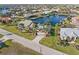 Aerial view of a home with a green roof, lush landscaping, and a waterfront view from its frontage at 1701 Casey Key Dr, Punta Gorda, FL 33950