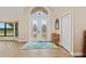 Bright foyer with decorative glass double doors, hardwood floors, and high ceilings at 1701 Casey Key Dr, Punta Gorda, FL 33950