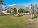 Inviting home exterior boasting a well-manicured lawn, tropical landscaping, and a charming entrance with a decorative front door at 1701 Casey Key Dr, Punta Gorda, FL 33950