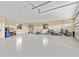 Spacious three car garage with epoxy flooring and fitness equipment at 1701 Casey Key Dr, Punta Gorda, FL 33950