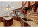 Modern kitchen with wooden cabinets, granite countertops, and large kitchen island at 1701 Casey Key Dr, Punta Gorda, FL 33950