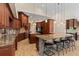 Gourmet kitchen features wood cabinetry, stone countertops, double ovens, and island seating at 1701 Casey Key Dr, Punta Gorda, FL 33950