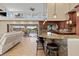 Open concept kitchen with barstool seating, wooden cabinets and a great view of the water at 1701 Casey Key Dr, Punta Gorda, FL 33950