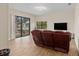 Bright living room with water view, wood-look tile flooring, and comfortable reclining sofa at 1701 Casey Key Dr, Punta Gorda, FL 33950