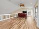 Large living room with wood-look flooring, recliner seating, and a view of the outdoor area at 1701 Casey Key Dr, Punta Gorda, FL 33950