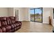 Inviting living room featuring wood-look tile floors, comfortable seating, and picturesque canal views at 1701 Casey Key Dr, Punta Gorda, FL 33950