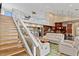 Open living space with a blend of seating and dining areas, with a staircase leading to upper levels at 1701 Casey Key Dr, Punta Gorda, FL 33950