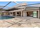 A covered outdoor pool with a bar area and patio offers an inviting space for relaxation and entertainment at 1701 Casey Key Dr, Punta Gorda, FL 33950