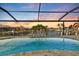 A beautiful pool and canal view from the enclosed lanai provides a serene outdoor living experience at 1701 Casey Key Dr, Punta Gorda, FL 33950