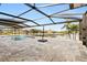 Screened-in pool area with beautiful waterfront views and travertine patio at 1701 Casey Key Dr, Punta Gorda, FL 33950