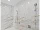 Luxurious shower featuring marble tile and multiple shower heads at 1701 Casey Key Dr, Punta Gorda, FL 33950