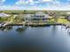 Scenic water view of the home featuring a private dock, lush landscaping, and a screened-in patio at 1701 Casey Key Dr, Punta Gorda, FL 33950